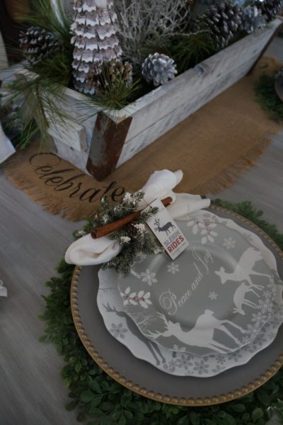 christmas dining room silver and gold table setting with greenery