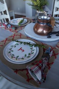 Casual Christmas table setting with red, green, white plaid. Burlap and handmade lazy susan for centerpiece. The perfect and easy table setting this holiday season