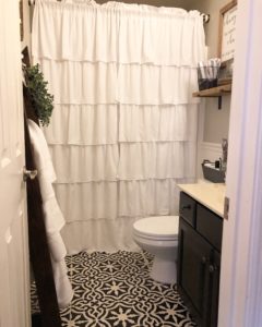 budget bathroom makeover for the $100 room challenge. stenciled floors, painted cabinet and walls and new decor
