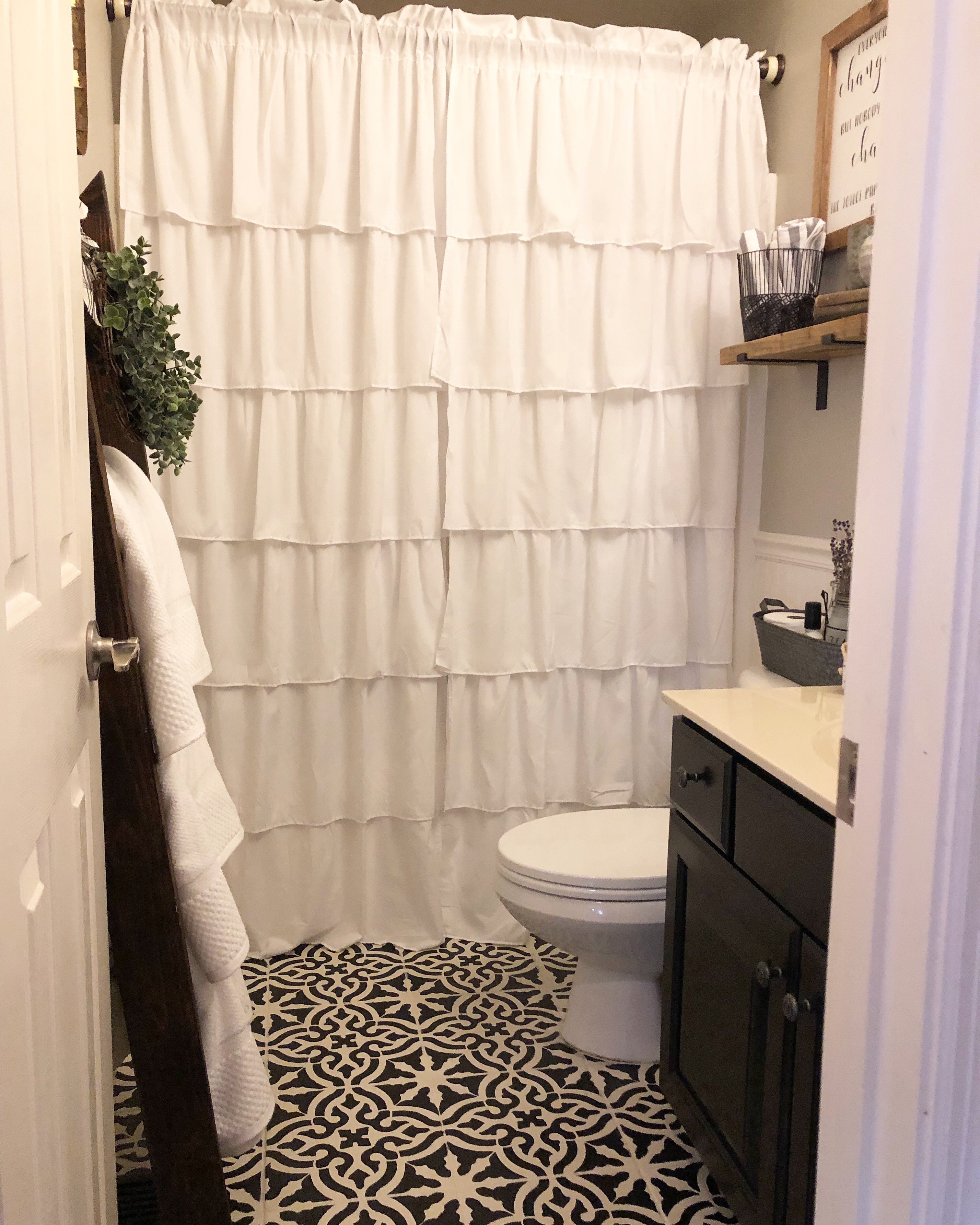 budget bathroom makeover for the $100 room challenge. stenciled floors, painted cabinet and walls and new decor