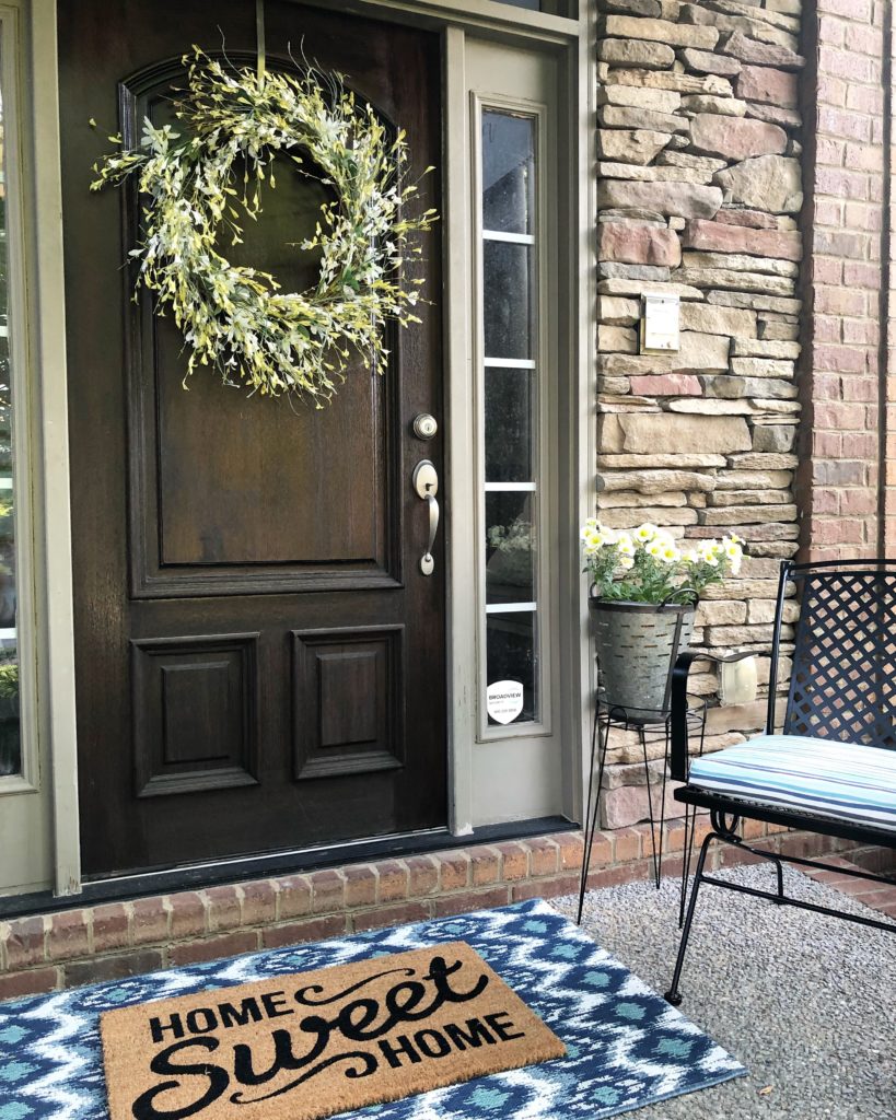 Summer Front Porch View with layered rugs navy and teal Wilshire