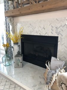 Farmhouse fireplace decor for floor, vases with flowers, lanterns and straw belly basket