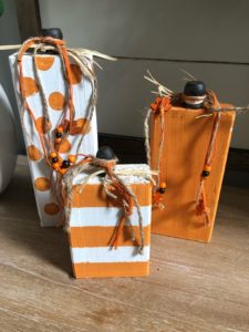 DIY wood pumpkins painted orange and white for Fall