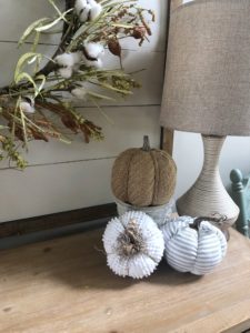 Neutral fall entry way with pumpkins, galvanized metal and cotton wreath on a shiplap frame