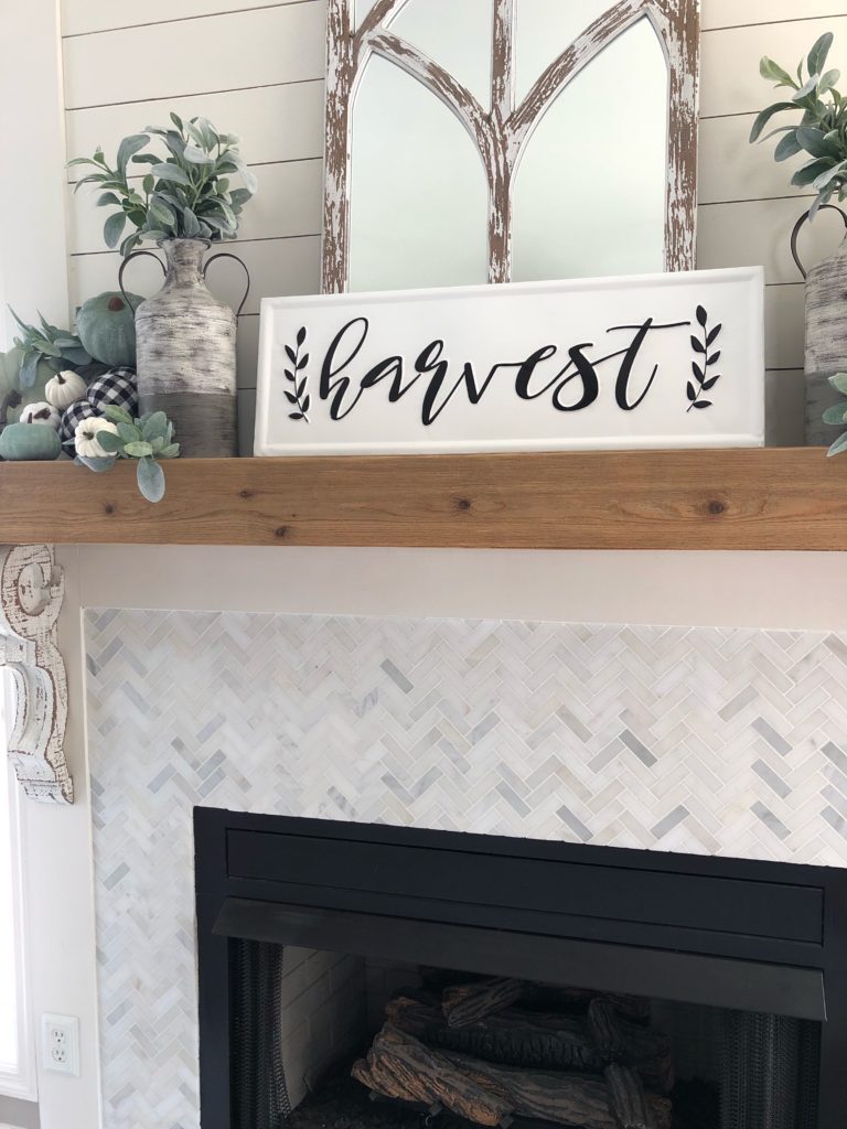 fall fireplace with buffalo check and sage green pumpkins and harvest sign from kirkland's