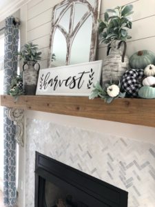 fall fireplace with sage green and buffalo check pumpkins