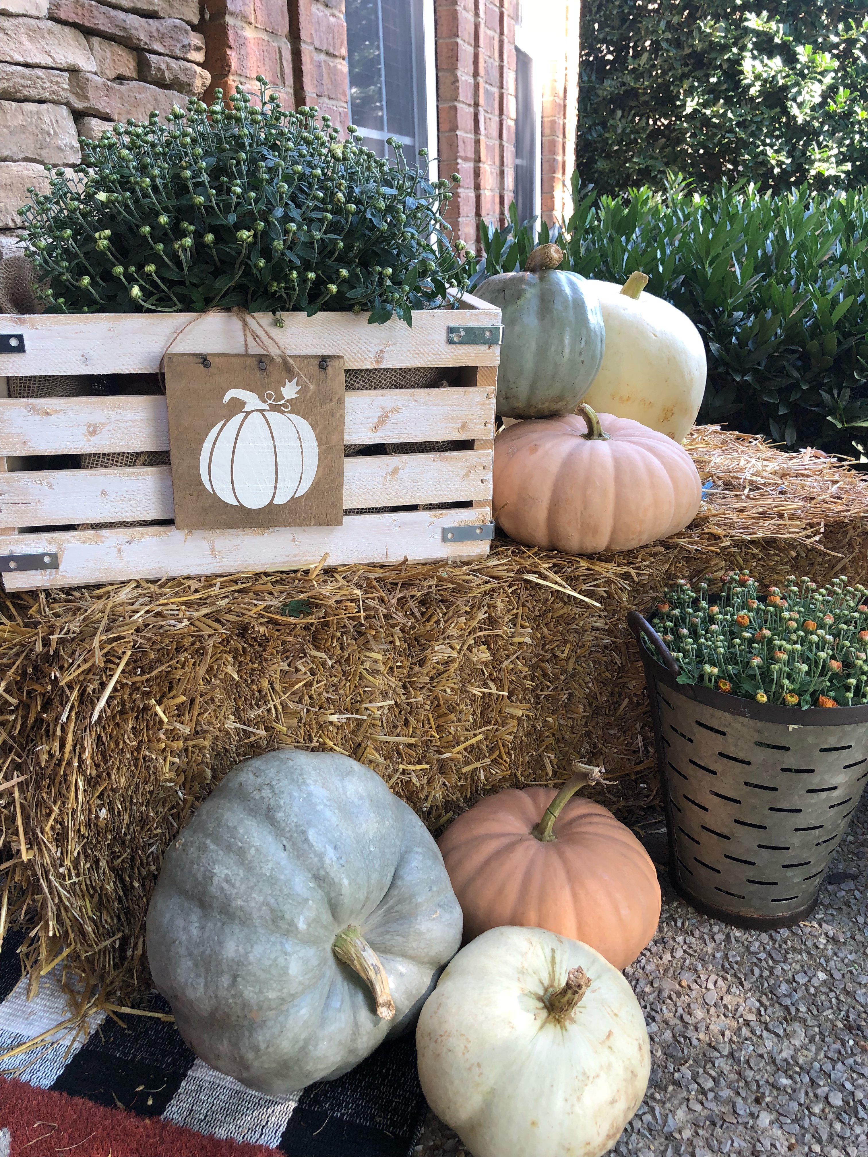 Fall front porch makeover with muted green, orange and white pumpkins. DIY crate and mums