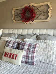 4 ideas on how to add Christmas decor to your master bedroom with pillows and a wreath