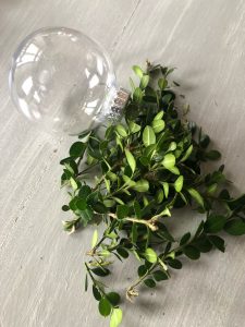 DIY Christmas ornaments using plastic ornaments and real greenery