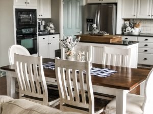 Classic farmhouse table with wood top, white bottom and farmhouse chairs for the perfect traditional and farmhouse vibe!
