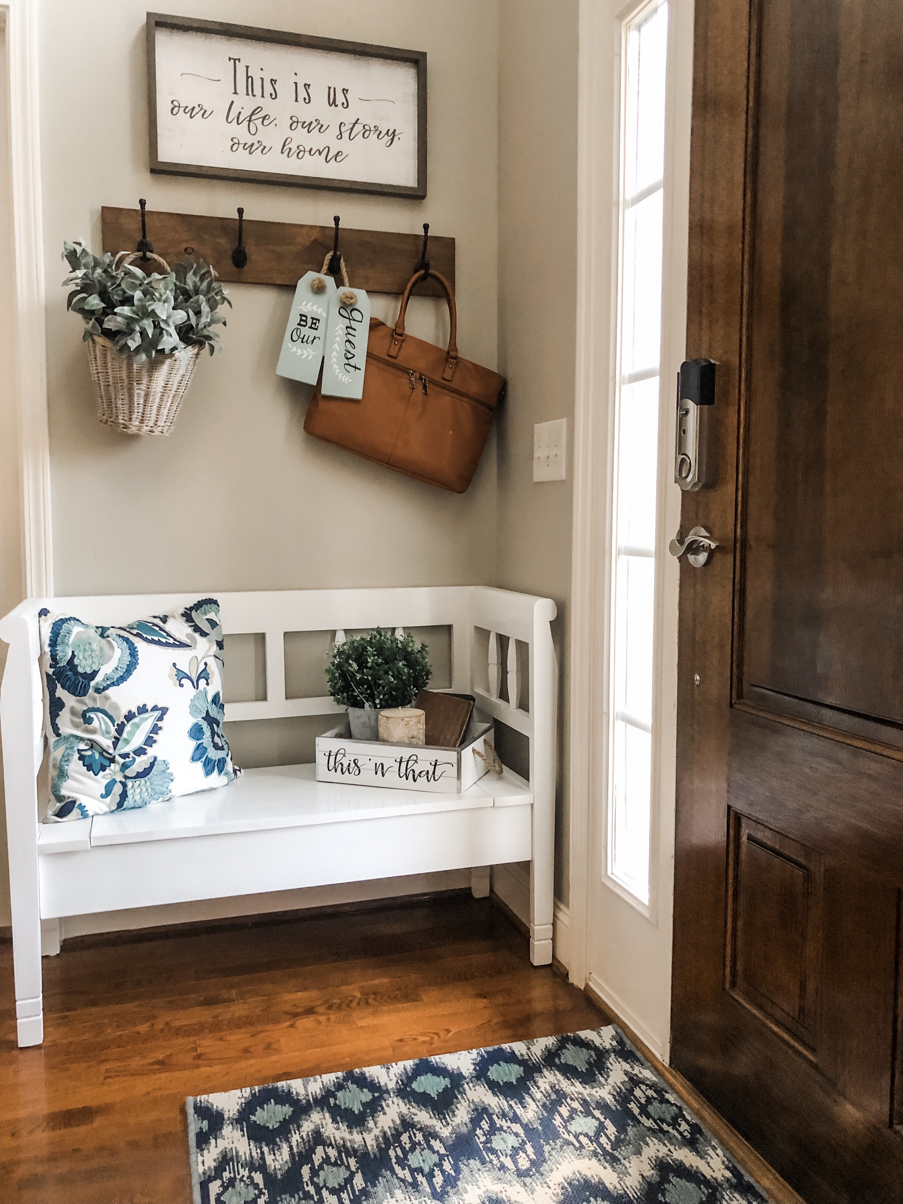 Entry way decorating ideas with a bench, hooks and cute farmhouse decor