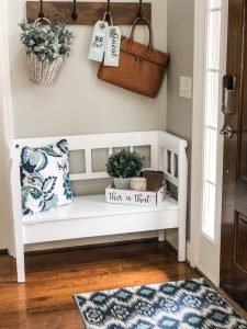 Entry way decorating ideas with a storage bench, decor and hooks