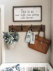 Entry way decorating ideas with a storage bench, hooks and decor