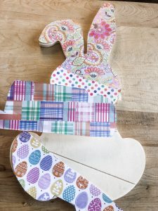 DIY wood bunny turned into darling easter decor with spring scrapbook paper