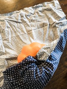 Easy no sew fabric pumpkins, wrapping the fat quarter fabric around the pumpkin