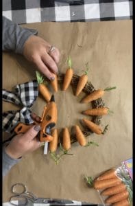 gluing carrots to bamboo wreath