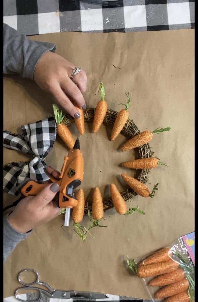 gluing carrots to bamboo wreath