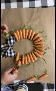 gluing carrots on to bamboo wreath