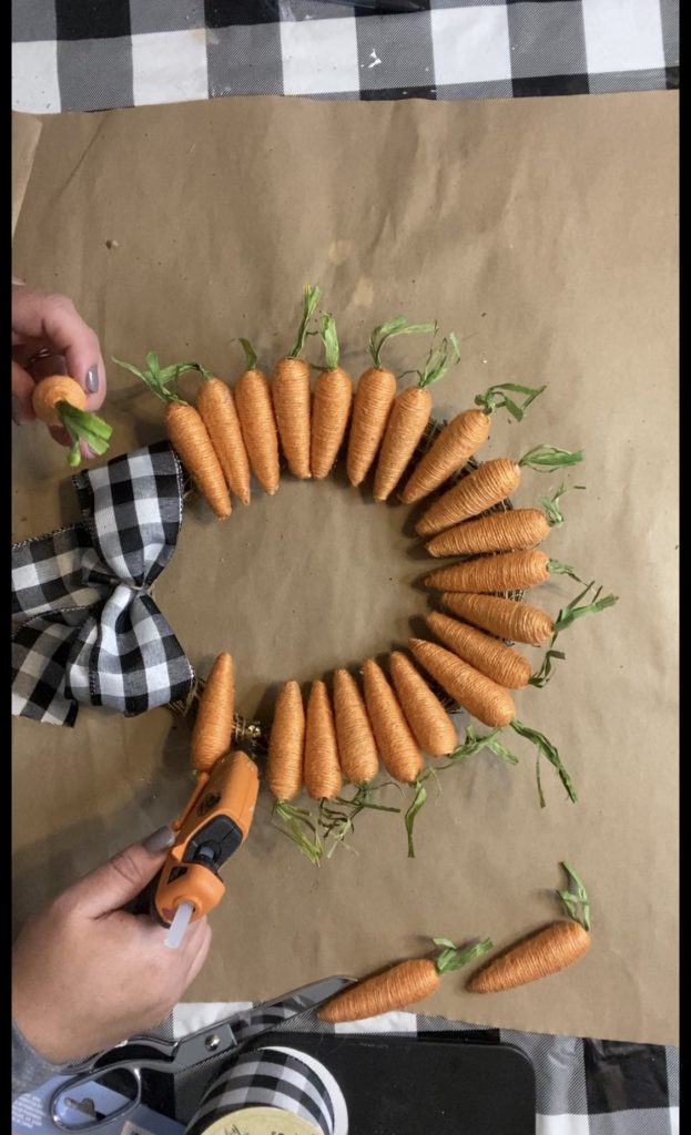 gluing carrots on to bamboo wreath